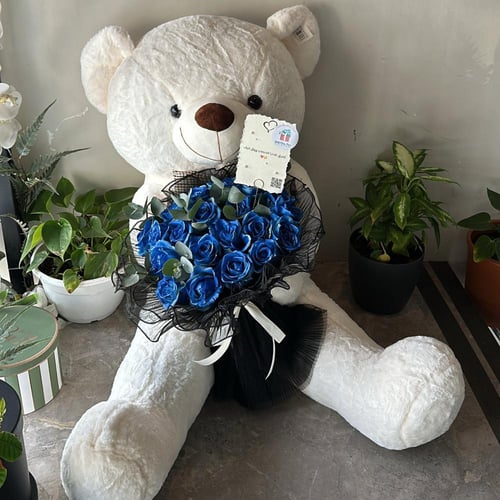 دبدوب كبير مع باقة ورود حمراء