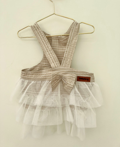 Beige dress below the dress of white tulle