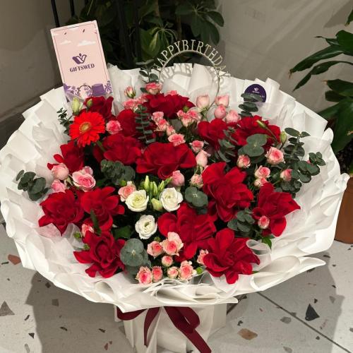 A bouquet of different flowers in a beautiful arra...