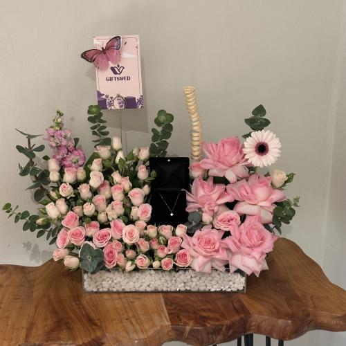 Luxurious pink flower arrangement with 18-karat go...