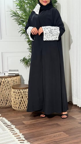 A practical abaya made of washed summer crepe and white Dattinal Thai with a flared cut