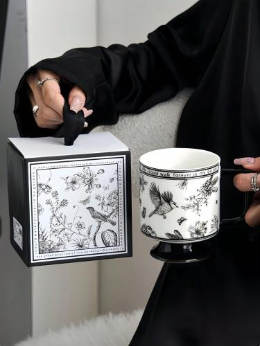 Black and white ceramic mug with classic floral pa...
