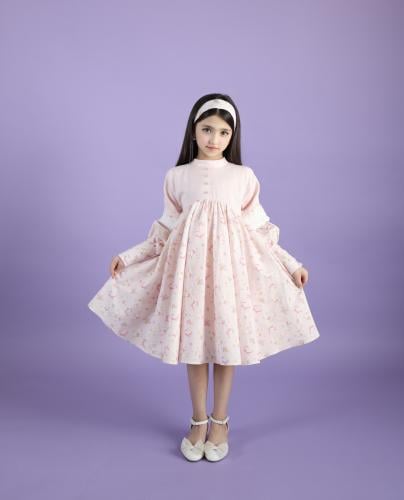 A designer dress made of fabric decorated with small sheep drawings and more playful and elegant details