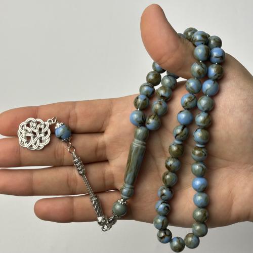 A turquoise beaded rosary with brown patterned beads