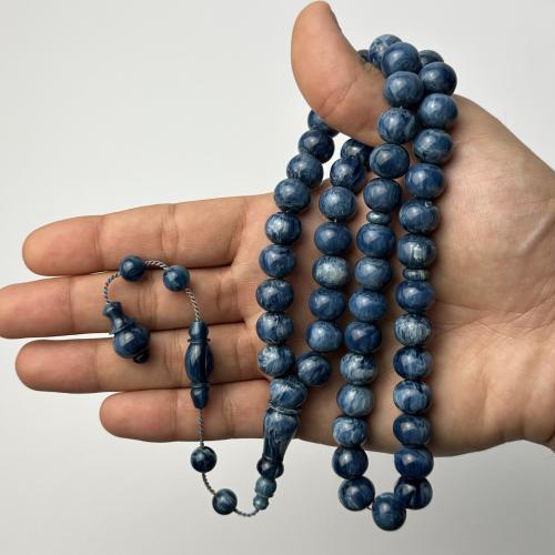 A petrol-colored, marbled prayer bead (indigo and brown) - Zuroy story and 51 Tamlika beads, twisted thread