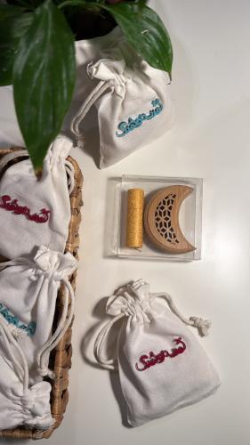 The incense holder of the crescent in a cloth bag and acrylic frame