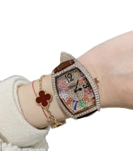 Rose gold watch with brown strap