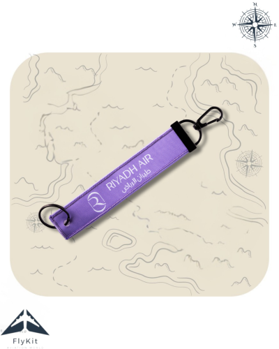 تعليقة طيران الرياض باللون الأبيض والبنفسجي