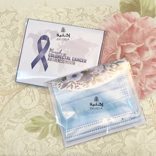توزيعات كمامه مع ثيم توعية بسرطان القولون والمستقي...