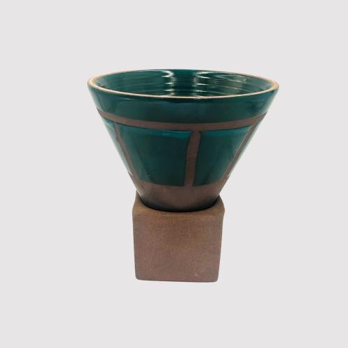 An oil-colored clay cup with a base