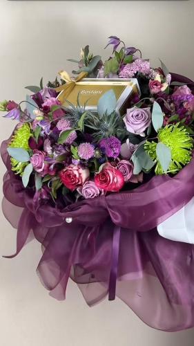 A bouquet of flowers with Bostani chocolates