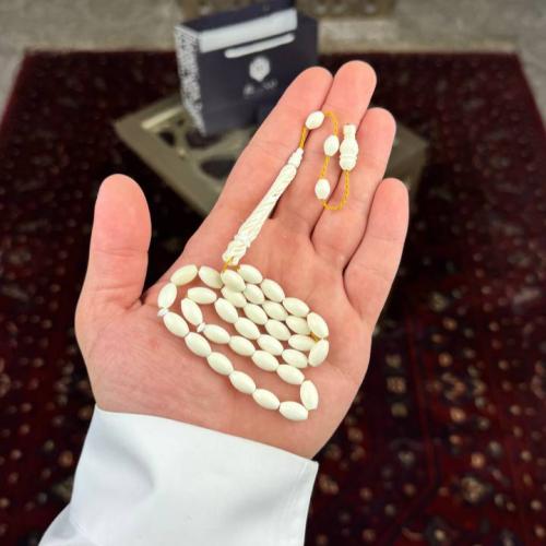 An ivory camel bone rosary with an oval story