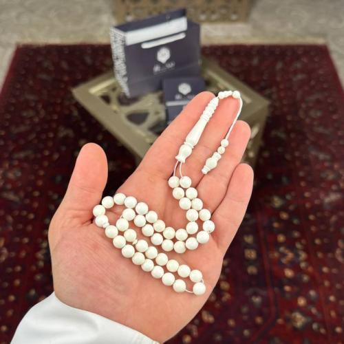 A camel bone prayer bead with a circular story