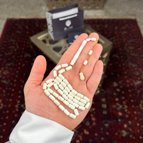 A camel bone rosary with a barrel-shaped story