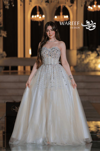 فستان بيج طويل بأحجار لامعة وتنورة واسعة