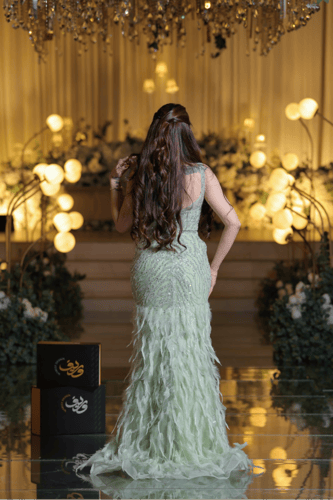 فستان سهرة أخضر فستقي مطرز بتفاصيل ريشية وقصة ميرم...