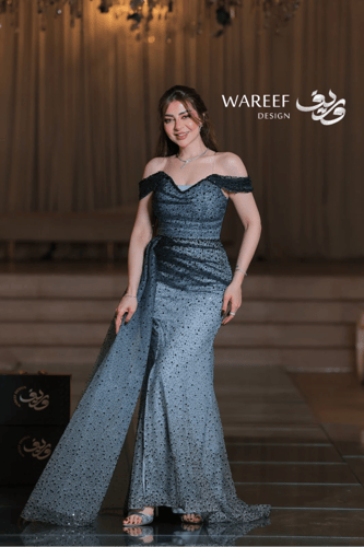 فستان سهرة أزرق سماوي طويل قما شبكي ومطرز بترتر أس...