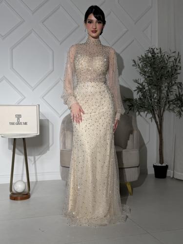 A dress with long sleeves and a fully beaded high neckline.