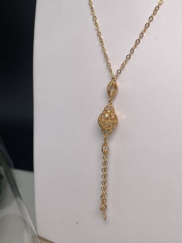 سبحة ذهبية بنقوش كروية ومربعات هندسية عيار 21