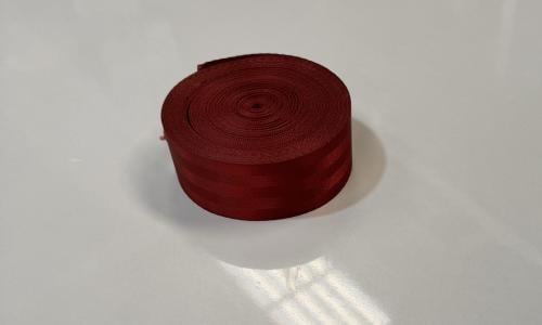 Modern manufacturing seat belt roll dark red enoug...