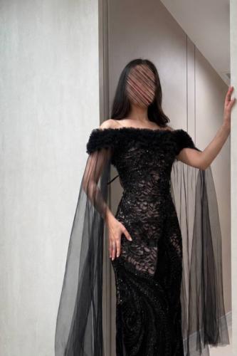Black dress with off-shoulder design and tulle sleeves
