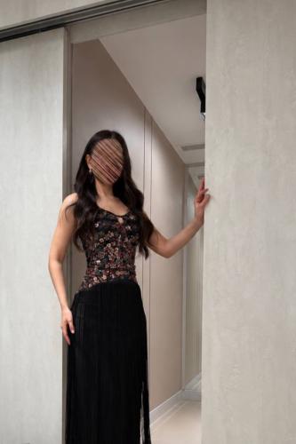 A feminine black dress with a soft cut