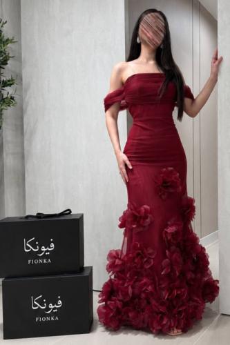 A red dress with a tight fit that accentuates the figure, decorated with prominent flowers
