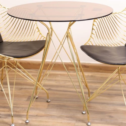 طقم طاولة طعام ستيل ذهبي بسطح قزاز دائري مع 2 كراس...