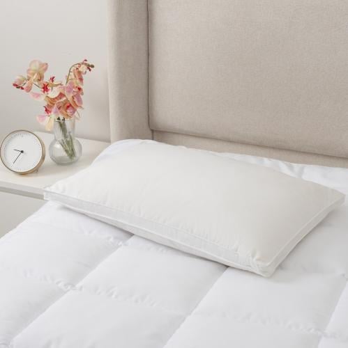 A pillow made of soft feathers and luxurious cotto...