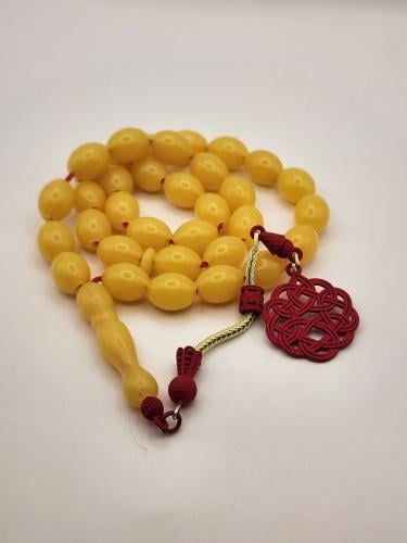 سبحه شبيه الكهرمان مع طربزونه حمراء 33 خرزه قص زيت...