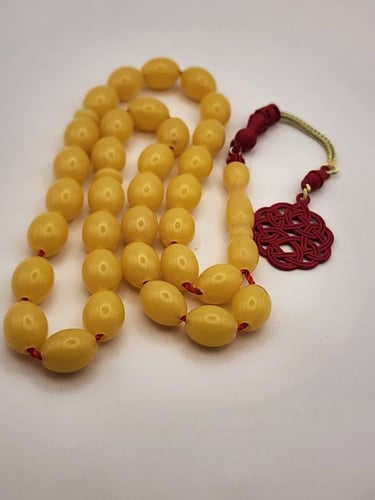 سبحه شبيه الكهرمان مع طربزونه حمراء 33 خرزه قص زيت...