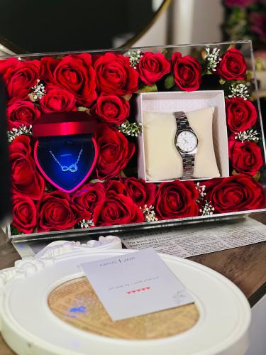 An elegant watch with an infinity necklace with a heart