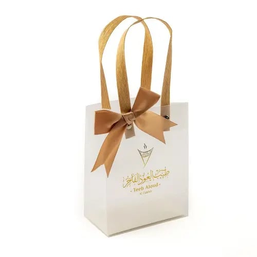A transparent gift bag with a golden bow
