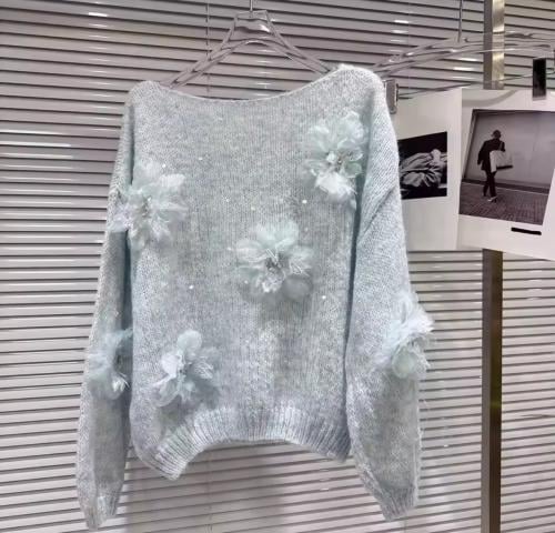 A soft knitted sweater adorned with delicate 3D fl...
