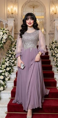 Royal purple evening dress with gold embroidery and a flowing pleated skirt