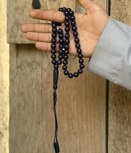 A dark blue beaded rosary