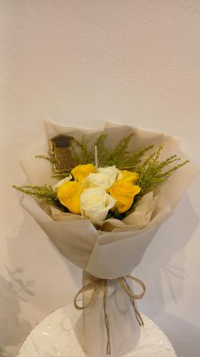 A bouquet of natural yellow and white roses with a...