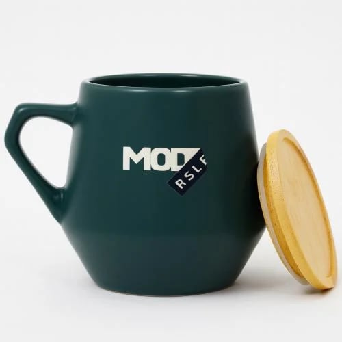Green ceramic mug with wooden lid
