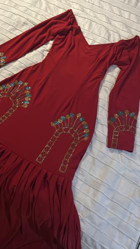 The sheikh's dress is luxurious red crystal with tears underneath