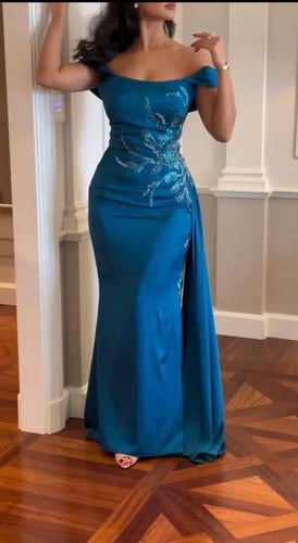 فستان سهرة فاخر بأكتاف مكشوفة وتطريز لامع”