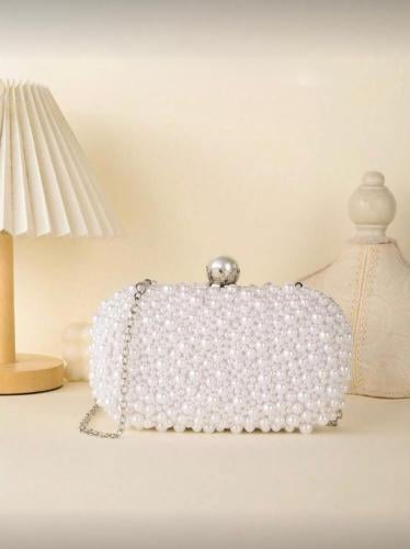 A clutch for evening, decorated with small pearls,...