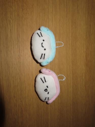 A Bisoos pendant wearing headphones