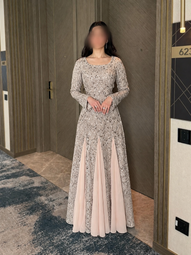 Luxurious evening dress with tulle, embellished with sequins, and chiffon pleats