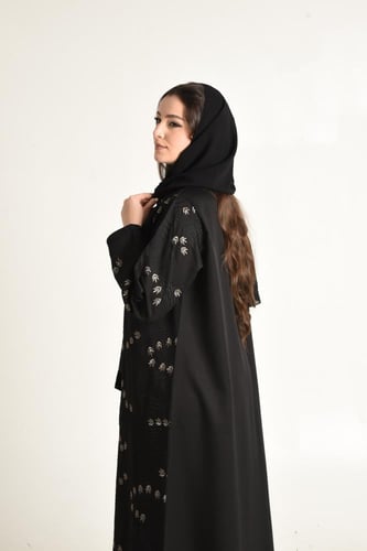 عباية فخمة بتطريز راقٍ يزيّن الجانب الأيسر بألوان...