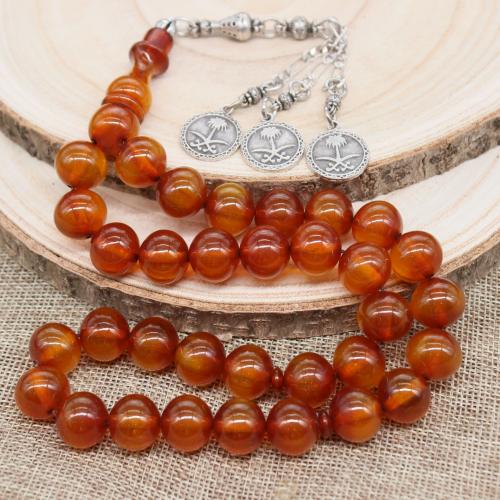 سبحة فاتوران عسلي معتقة بشرابة تحمل شعار المملكة