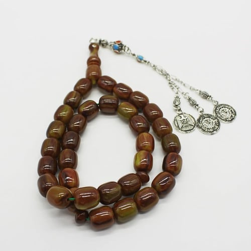 سبحة مسكي زيتي ممزوج بالبني بحبات أسطوانية كبيرة و...