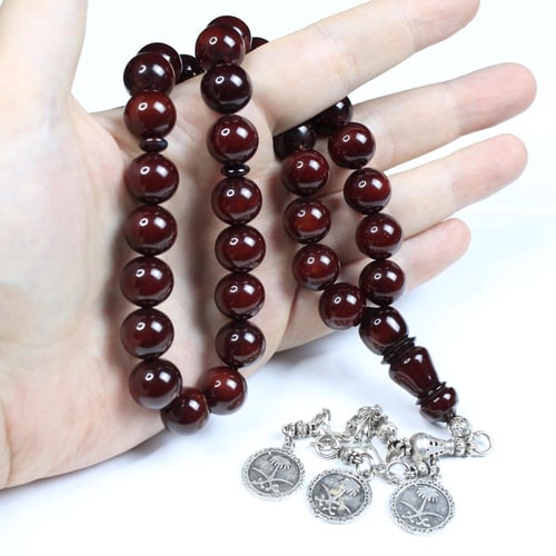 سبحة مسكي عسلي ممزوج بالاسود معتقة بشرابة تحمل شعا...