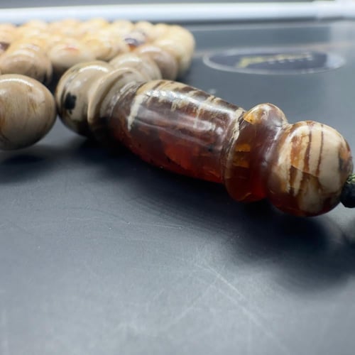 سبحة كهرمان سومطري ملطخ قص بيضاوي