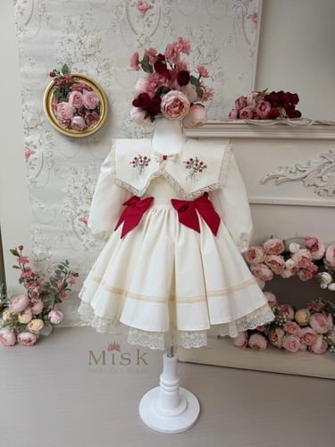 فستان كريمي بفيونكات حمراء