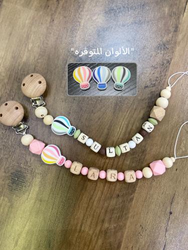 A holder for a pacifier with the name, in the shap...